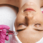 Esthetician performing a nano infusion facial on a client using a precision device to enhance product absorption and boost skin radiance at Spirit & Body Massage in Prescott Valley, AZ.